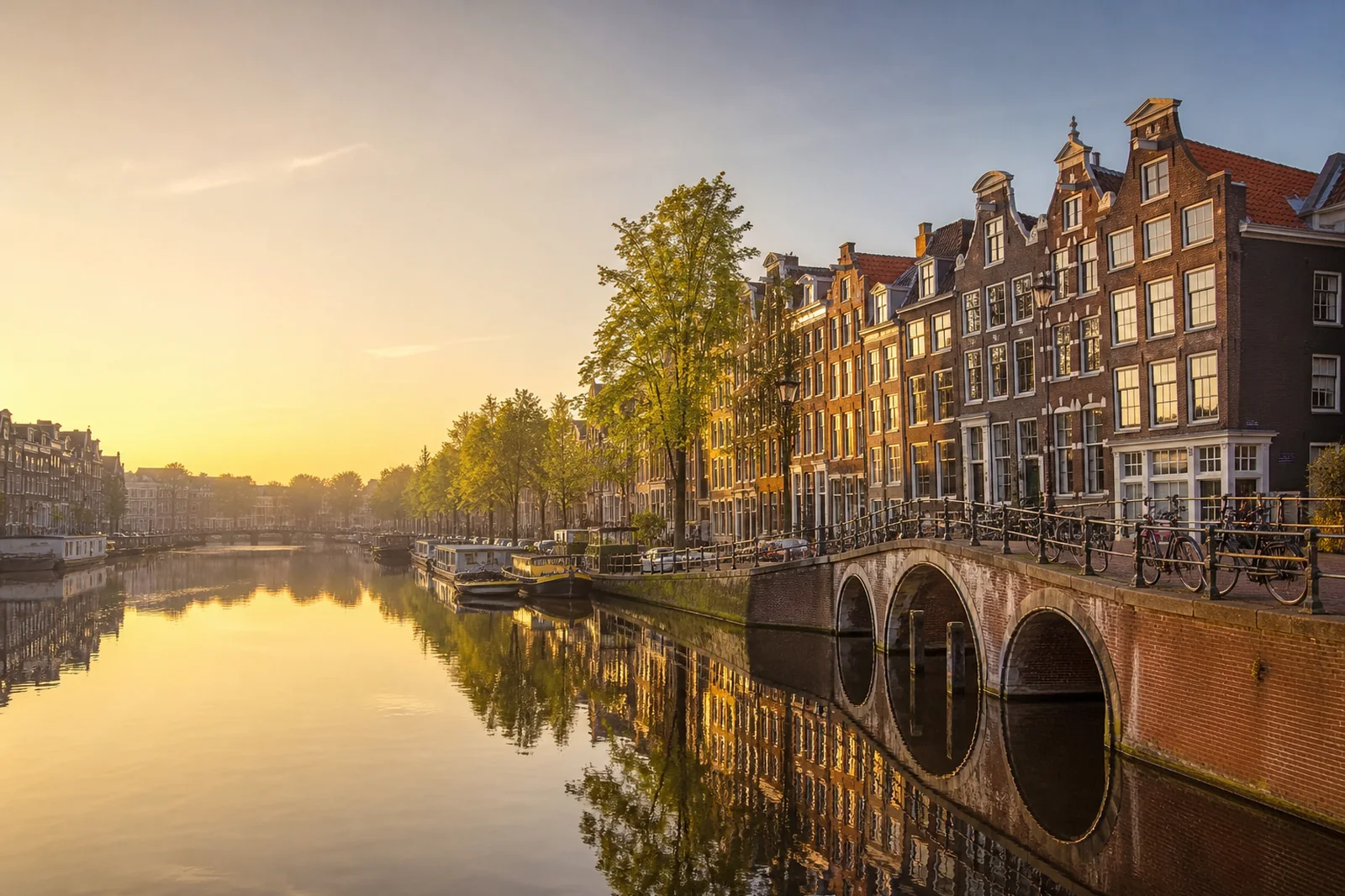 Amsterdam canal houses and a quiet canal at golden hour