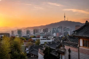 Seoul skyline with traditional palace roof and modern towers at sunset
