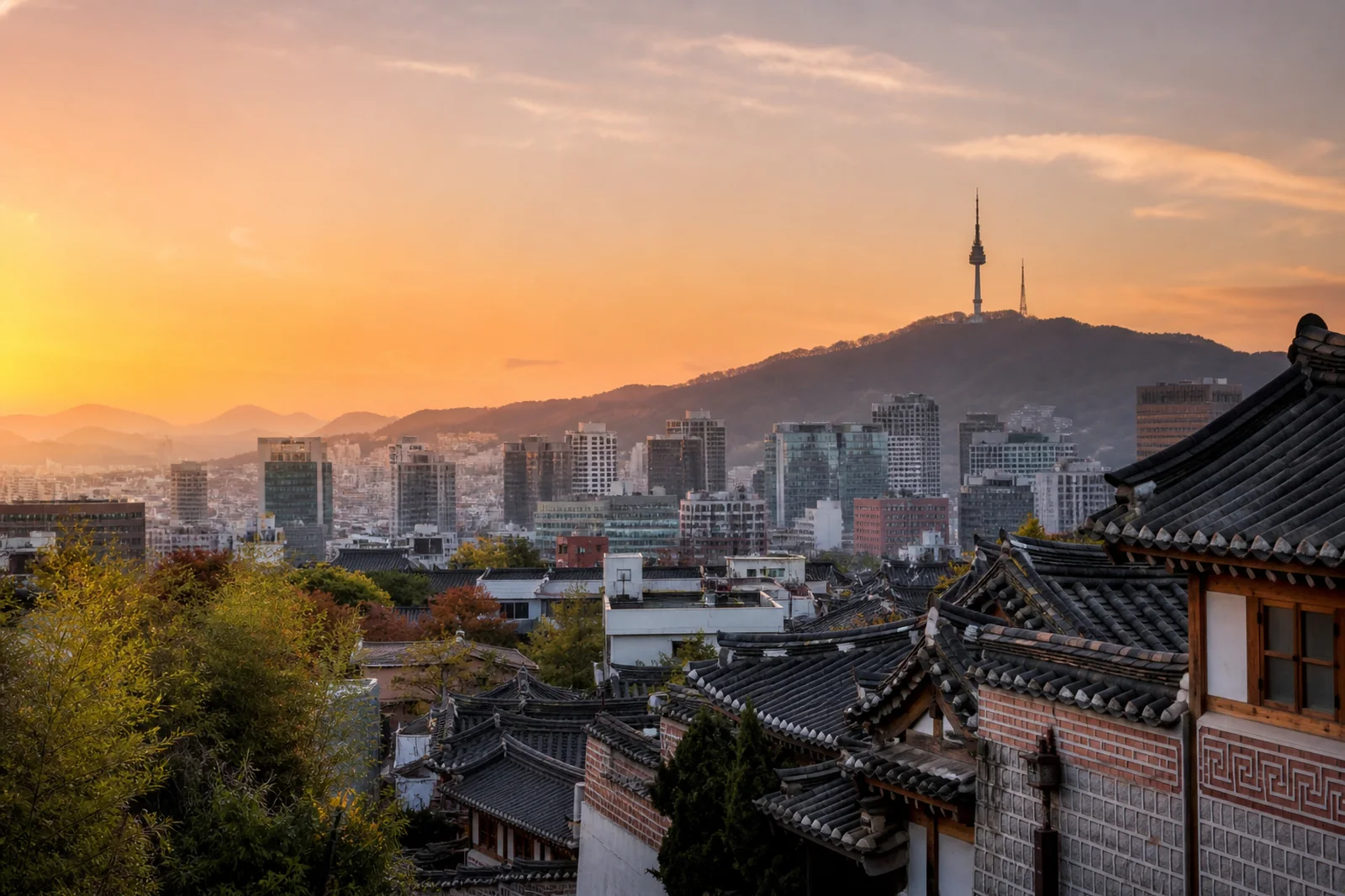 Seoul skyline with traditional palace roof and modern towers at sunset