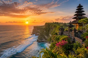 Bali clifftop temple and tropical coastline at sunset