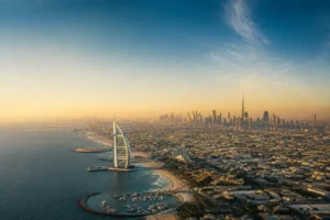 Aerial view of Dubai's skyline and coast in clear golden-hour light