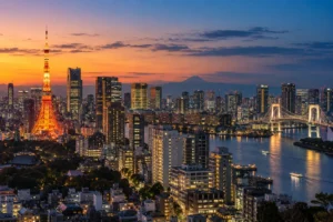 Tokyo skyline at twilight with Tokyo Tower, waterfront lights and Mount Fuji in the distance