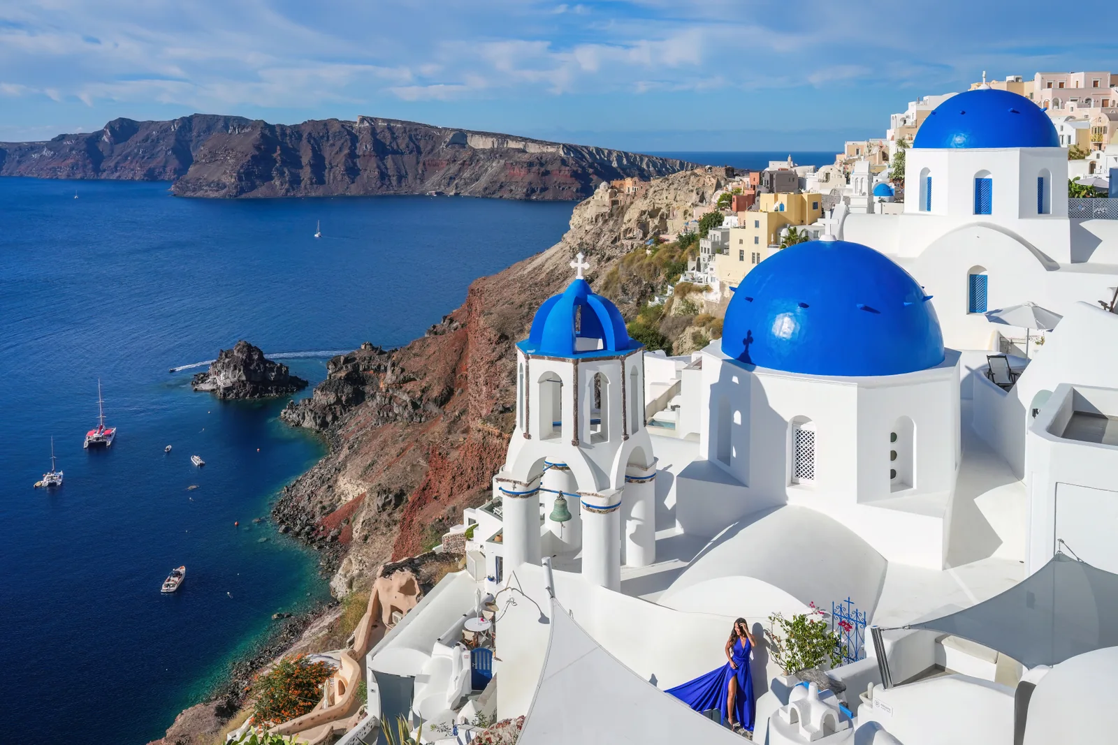 Blue-domed churches and white buildings overlooking the sea in Oia, Santorini