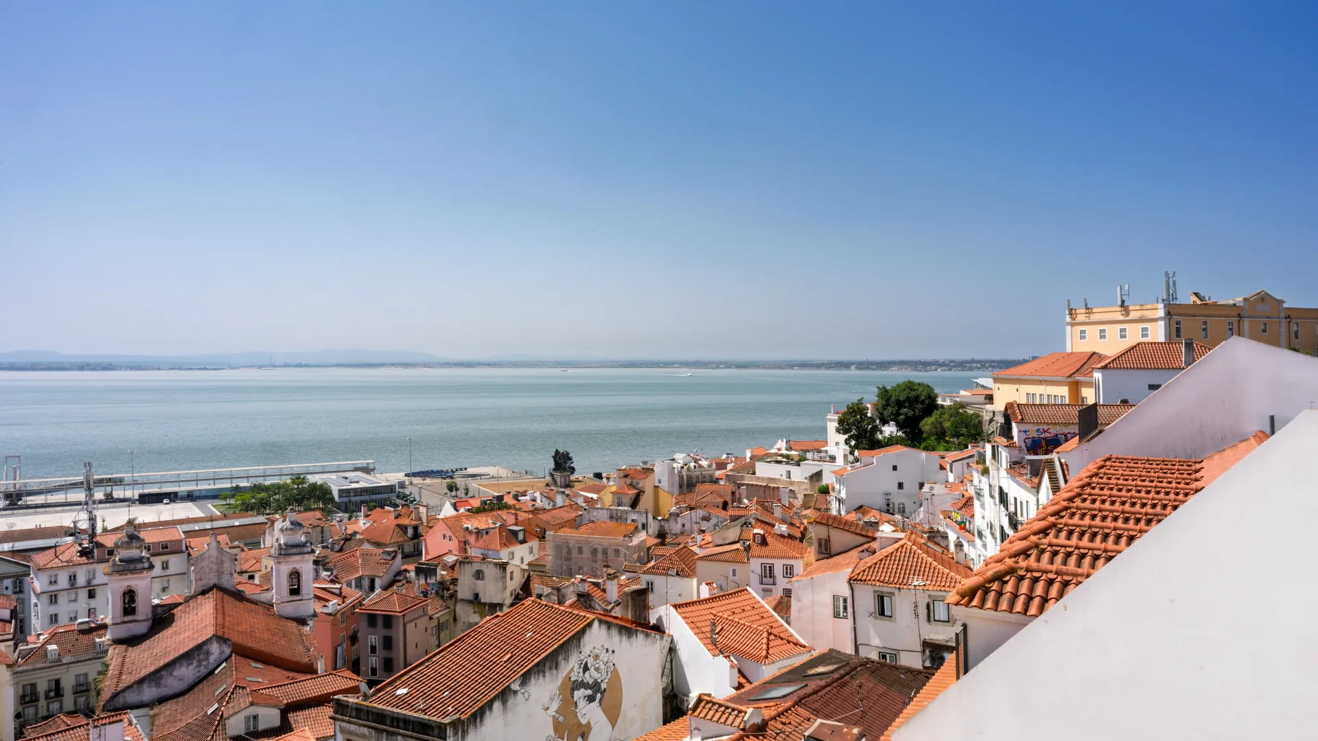 Terracotta rooftops of Alfama overlooking the Tagus River in Lisbon