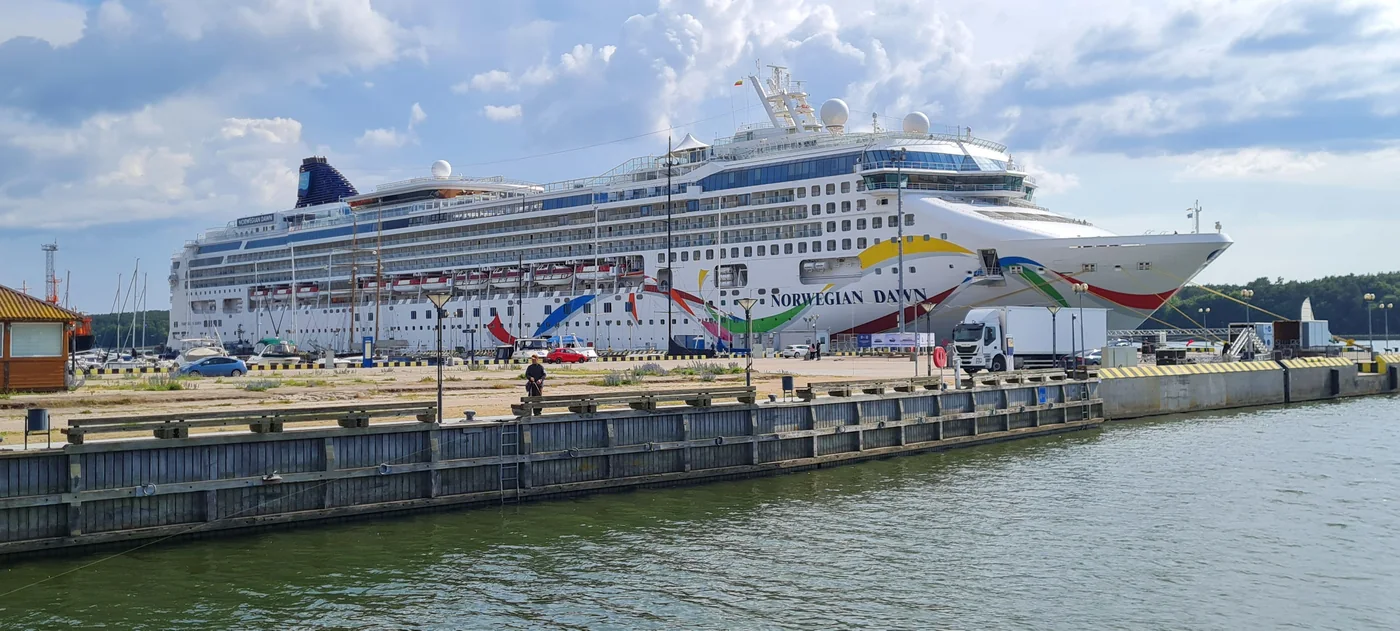 Norwegian Dawn showing its colourful hull and passenger decks
